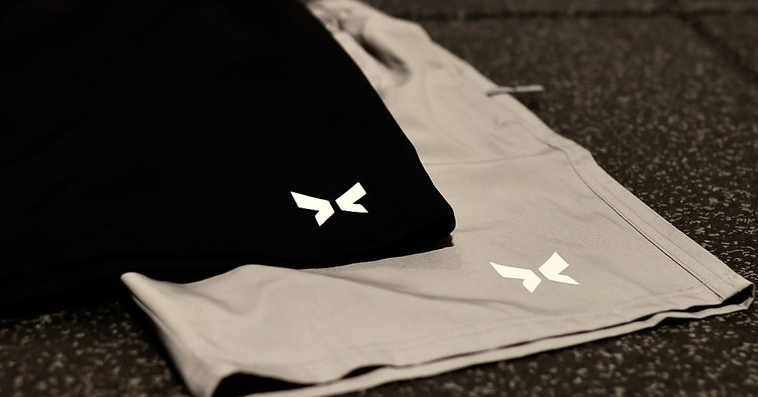 Shapeshift black and grey gym shorts for men featuring breathable, quick-dry fabric and a flexible athletic fit designed for performance and comfort during training.